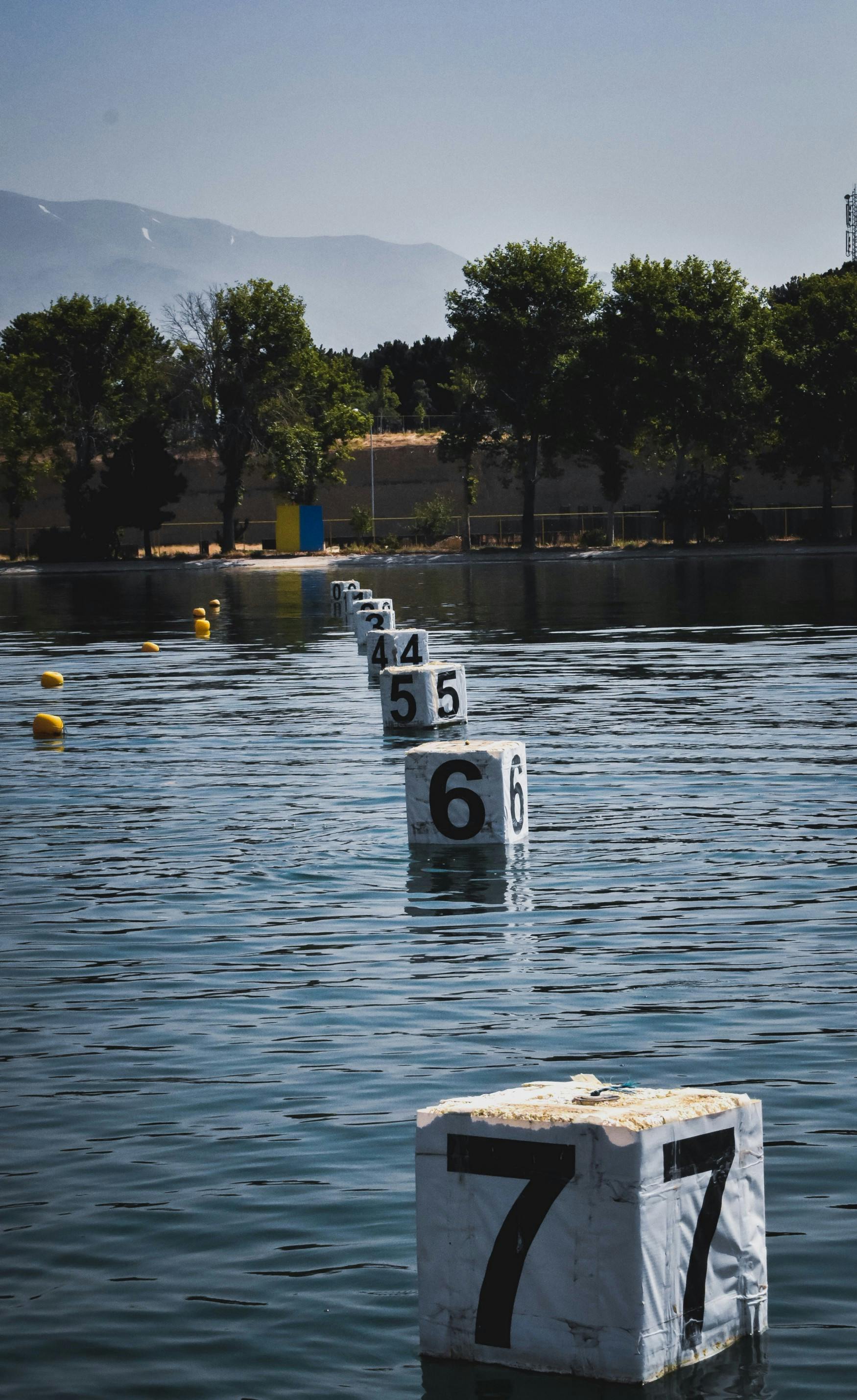 A lake with buoy's with numbers on them